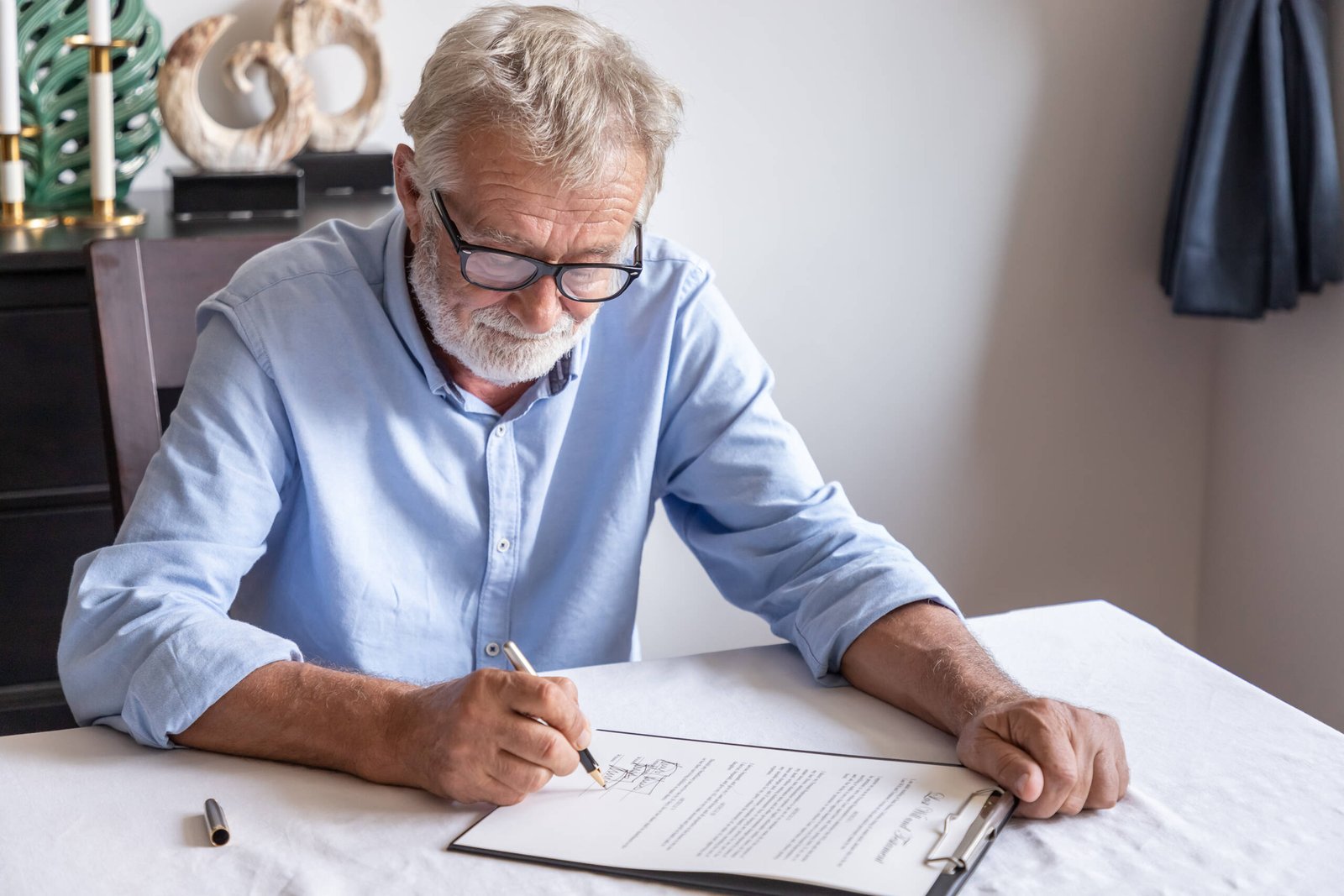 Senior old man elderly examining and signing last will and testament for family inheritance.